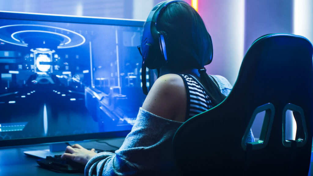 Gamer Girl Playing in First-Person Shooter Online Video Game