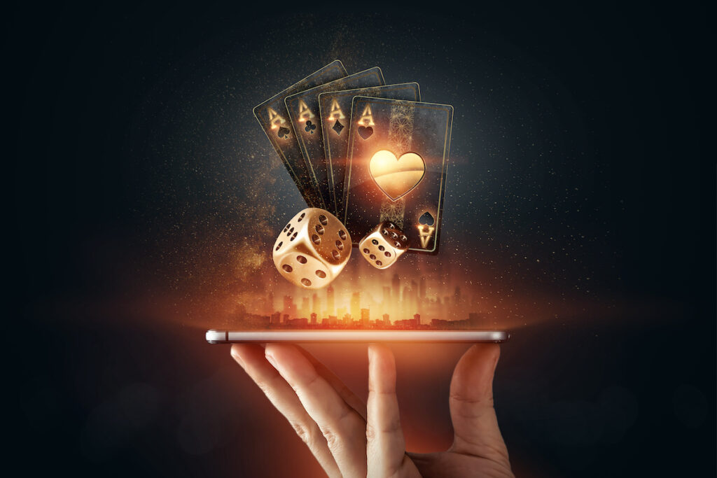 online casino, a smartphone with playing cards, roulette and chips